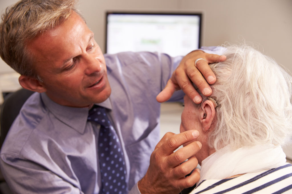 Man being fitted with hearing aids in El Paso