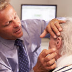 Man being fitted with hearing aids in El Paso