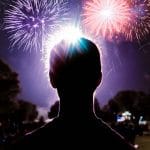 silhouette of a person watching fireworks