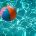 A beachball floating in a pool.