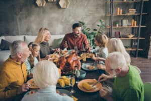 Large cheerful family enjoying a holiday meal.
