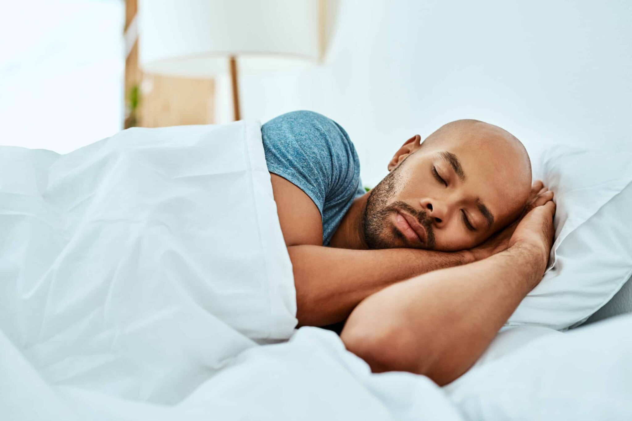 Man sleeping comfortably in bed.