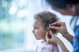 Young girl getting her first hearing aids