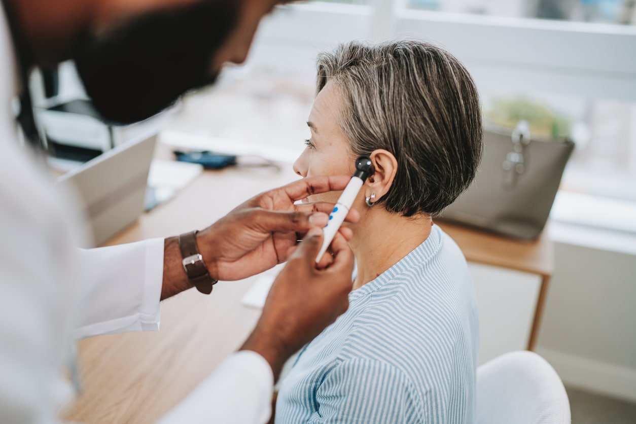 Doctor examining a patient's ear.