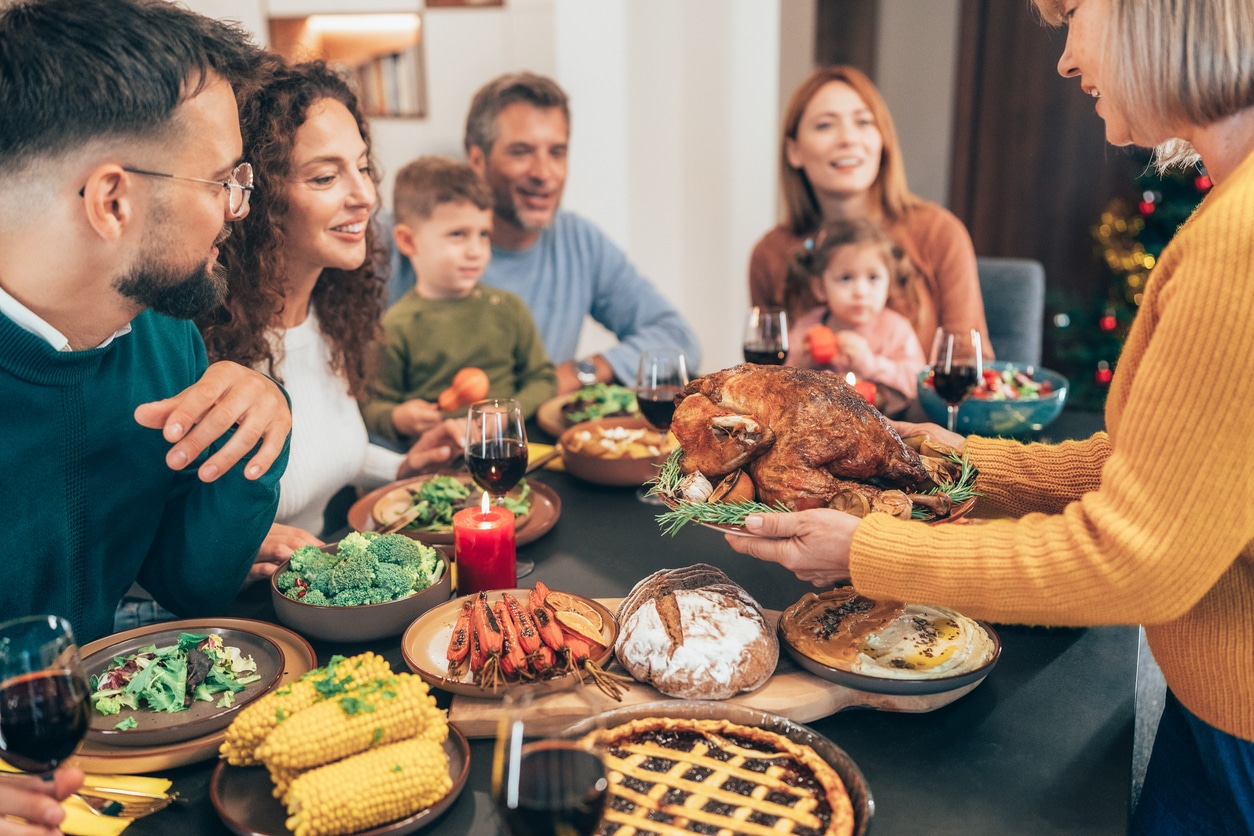 Family enjoying thanksgiving dinner together.
